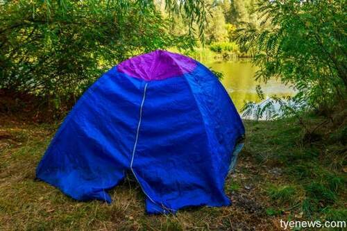 blue camping tent forest near river